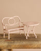 Maileg Garden Tea Set consisting of a miniature pale pink metal garden bench and matching round table.
