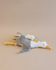 Two Senger Naturwelt Cuddly Animal Seagull toys filled with organically grown cotton, lying side by side on a plain beige background, with one overlapping the other slightly, both facing to the right.
