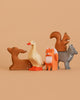 The Bumbu Handmade Wooden Woodland Animals Set features four charming wooden toys—a deer, duck, fox, and wolf with a squirrel—arranged in a row against a beige background, capturing the appeal of educational wooden toys.