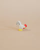 A small handcrafted Ostheimer Rooster - White with a red head and yellow feet positioned on a plain beige background.