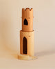 Ostheimer Round Tower With Stairs sculpture with a carved castle design, ideal for imaginative play, featuring arched and heart-shaped windows, displayed against a plain beige background.