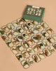 Memory Game - Animal Kingdom features vintage animal illustrations on cards arranged in a grid, packaged in a green checkered box with charming animal art at the top.
