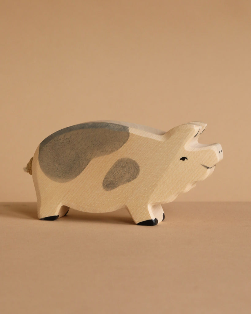 The Holtztiger Boar is a high-quality, handcrafted wooden figurine featuring light beige and gray spots, a smiling face, and minimal details. Perfect for any collection, it ships in one week.