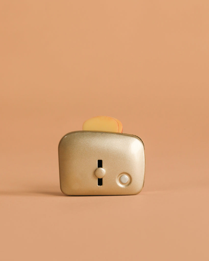 The Maileg Toaster with Bread, Large Size - Silver features a metallic finish and includes toy bread—perfect for any children's kitchen set.