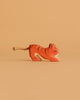 The Ostheimer Tiger Lurking, Small is a handcrafted wooden figurine with orange and black stripes and a rope tail, shown on a plain beige background.