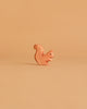 The Ostheimer Handmade Wooden Woodland Set features a small, minimalist wooden squirrel figurine displayed on a plain, light brown background—an elegant example of handcrafted toys made from sustainable materials.