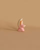 The Ostheimer Little Angel - Pink is a small, wooden figurine painted in soft pastel colors. This angel features light brown hair, a white halo, and wears a pink robe. Handcrafted from sustainably sourced materials, it stands in a prayerful stance with hands clasped together against a plain beige background, reminiscent of the charming style of Ostheimer toys.