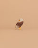 The Ostheimer Bald Eagle Family Set features small figurines with brown wings, white heads, and yellow beaks and feet—ideal for fans of handcrafted wooden toys or collectors of Ostheimer wooden toys.