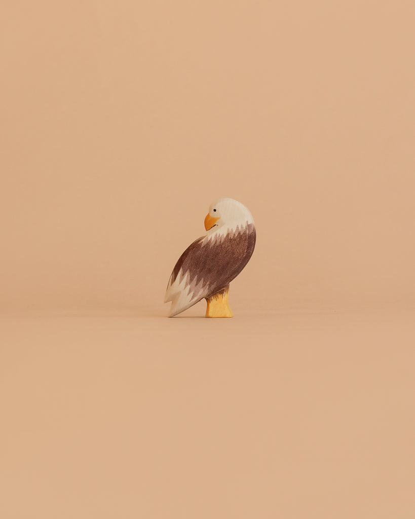 The Ostheimer Bald Eagle Family Set features small figurines with brown wings, white heads, and yellow beaks and feet—ideal for fans of handcrafted wooden toys or collectors of Ostheimer wooden toys.
