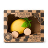 Lou The Lemon Baby Car is a yellow, lemon-shaped toy with green leaves and wooden wheels, made from natural rubber. Packaged in a "Oli & Carol Green Cars" box, it's eco-friendly and perfect for sensory play for babies aged 0+.