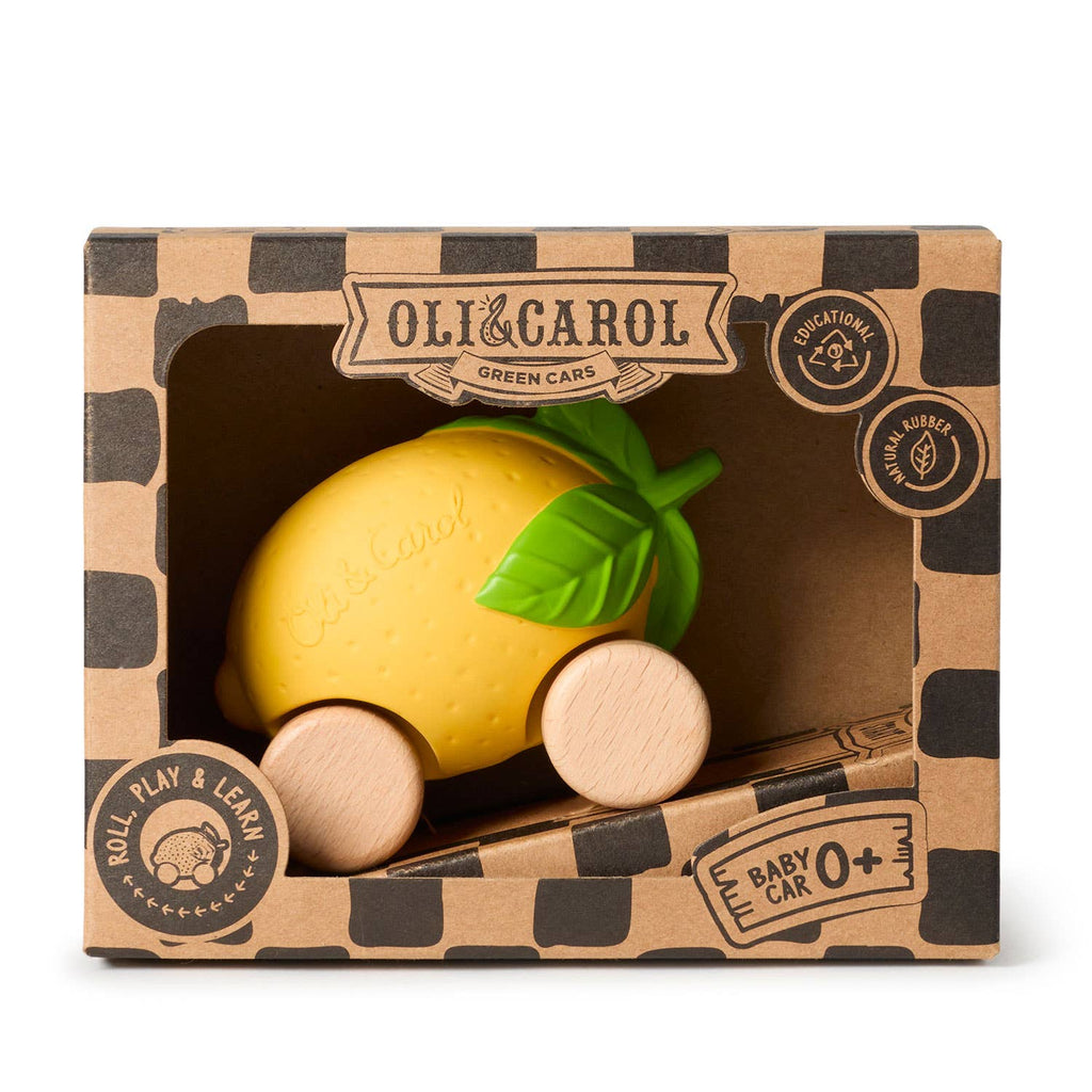 Lou The Lemon Baby Car is a yellow, lemon-shaped toy with green leaves and wooden wheels, made from natural rubber. Packaged in a "Oli & Carol Green Cars" box, it's eco-friendly and perfect for sensory play for babies aged 0+.