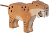 The Holztiger Saber-Toothed Tiger is a handcrafted wooden figure with painted orange and beige markings, black spots, a rope tail, and large carved fangs. Made in Europe, it features Holztiger's signature simple, stylized design.