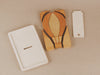 The Handmade Hot Air Balloon Puzzle features wood pieces treated with linseed oil. It's accompanied by a simple rectangular wooden box with a lid and detachable kickstand.