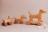 A delightful handmade push toy featuring a mini dog design, crafted from maple and beech wood, elegantly created for endless playtime adventures.