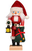 Christian Ulbricht Collectible Wooden Nutcracker - Santa with Lantern, depicted holding a lantern in one hand and a green gift sack filled with toys in the other.