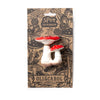 Two red and white Spot the Mushroom Teething Toys by Oli & Carol are attached to eco-friendly cardboard packaging with cute illustrations, ideal for sensory play and teething, made from natural rubber.