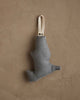 The Coral & Tusk Downhill Bear Ornament is a small, abstract-shaped fabric decoration in muted gray with a cream loop for hanging, adding winter charm to any beige textured wall.