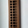 A close-up photo of a sustainably sourced Wooden Crayon Holder 12 Stick / 12 Block Slots with multiple circular indentations, each progressively larger, set against a white background.