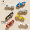 Seven Classic Wooden Sports Cars made from FSC-certified wood are displayed on a light background. The "7 piece set" text emphasizes the colorful, uniquely shaped cars with wooden wheels, designed for train track compatibility.