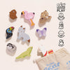The Andes Stacking Animals & Bag features wooden animal blocks—bird, cheetah, and llama—on a light surface with an open cloth bag. Icons show skills developed: coordination, imagination, and sensory play for creative stacking fun.
