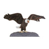 The Large Eagle Stuffed Animal is a model of a bald eagle with detailed brown feathers, a white head, and yellow beak. It has realistic features, outstretched wings, and perches majestically on a rock.