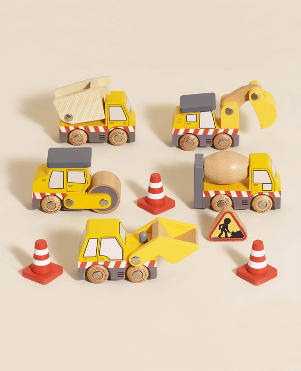 The Construction Toy Cars, Trucks & Diggers set (ships in one week) features a dump truck, excavator, road roller, and front loader with orange traffic cones and a roadwork sign for imaginative construction play on a light beige surface.