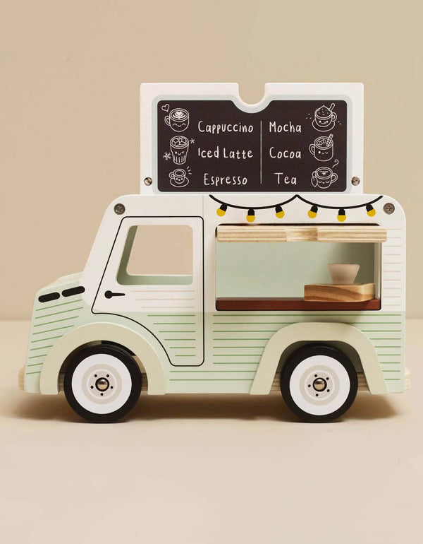 The Mobile Café Van is a vintage wooden toy with a chalkboard menu listing cappuccino, mocha, iced latte, cocoa, espresso, and tea. It has a serving window with cups and string lights—perfect for imaginative play.