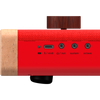 Close-up of the Loog Piano’s side panel, showing USB/MIDI, headphone out, sustain, and octave ports. The wood and fabric finish is accented by a large brown knob on top.