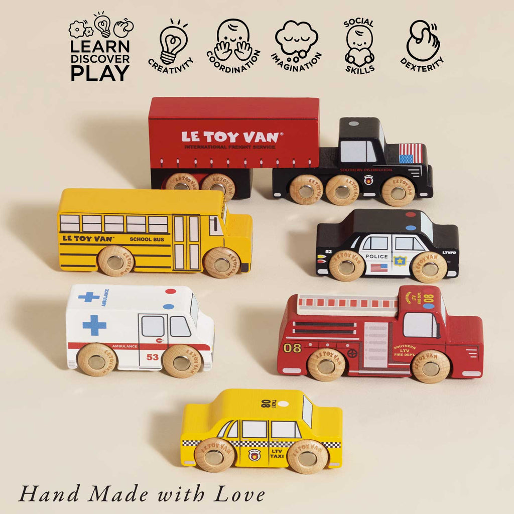 The American Wooden Car Set features six colorful vehicles—bus, ambulance, taxi, fire truck, police car, and truck—arranged on a light surface. A perfect toy gift to inspire creativity and skill development. “Hand Made with Love.”.