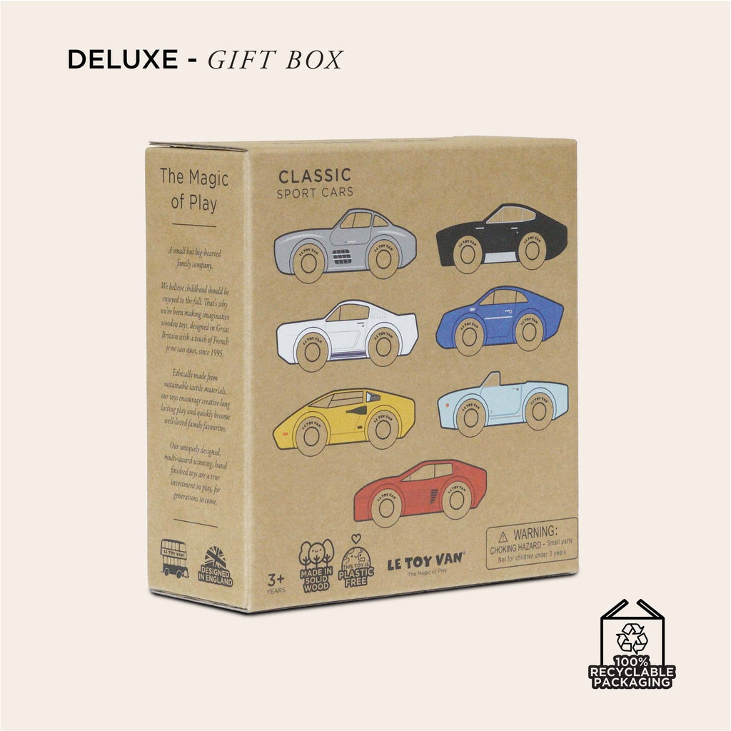 Brown box labeled "DELUXE - GIFT BOX" for Classic Wooden Sports Cars, featuring illustrations of colorful sports cars, phrases "The Magic of Play" and "RECYCLABLE PACKAGING," and a small parts warning. Made from FSC-certified wood and perfect for train track compatible playsets.