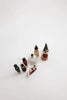 Seven small, hand-painted Sabo Concept Christmas Ornaments—featuring figures, a house, a sleigh, and trees—are displayed on a white background, perfect for enhancing your nutcracker ornament set.