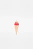 A minimalist artistic representation of a Handmade Ice Cream Cone made from cutout paper in pastel colors, with a pink scoop and a tan cone on a white background with faint circular patterns.