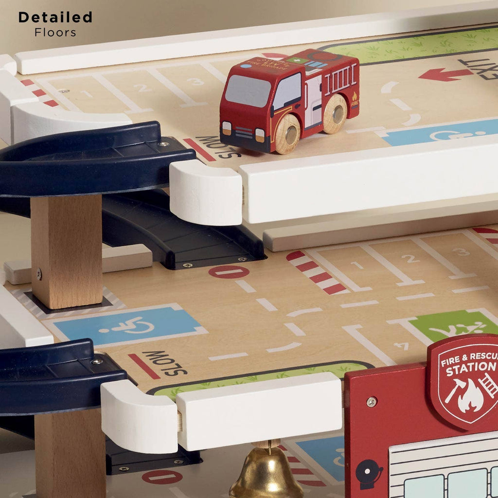 The Fire & Rescue Garage playset features a wooden toy fire truck on the upper level, with ramps, road markings, and a fire station design to inspire imaginative play.
