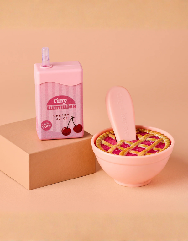 A Tiny Tummies Set - Cherry Pie Bowl and Juice Box featuring a juice box next to a magical bowl containing a lattice-topped cherry pie with a spoon inside.