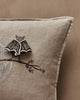The Coral & Tusk Bat Branch Pillow features beige bat wings, an embroidered tree branch with baby bats, and a 3D bat brooch. Set against a neutral wall, it's perfect for Halloween décor. Ships in one week.