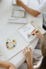 A child uses a water pen to reveal a paint palette illustration in a Winnie-the-Pooh: Pooh’s Birthday Surprise (Water Reveal) book.