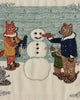 The Coral & Tusk Snowman Card features embroidered animals— a fox with a scarf and a bear with cub placing a carrot nose on the snowman— set against falling snow, making it an enchanting choice for winter décor.