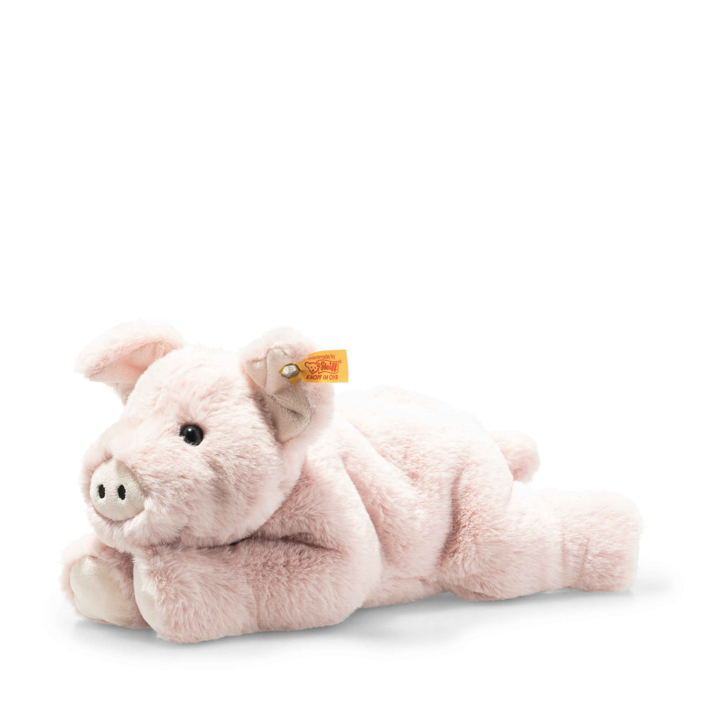 The Steiff Piko Pig Plush Toy (11 inches) is a soft, light pink pig lying on its stomach with a round snout, floppy ears, and a yellow tag with button on its ear. The background is plain white.