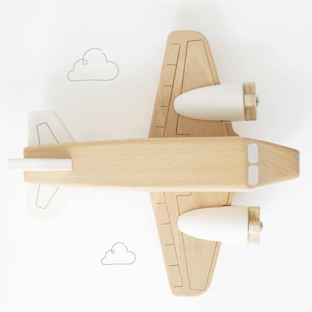 The Wooden Toy Plane, made from FSC-certified wood, is seen from above with drawn clouds in the background. Its light-toned, minimal design includes two white engines and is entirely plastic free—a charming eco-friendly toy.