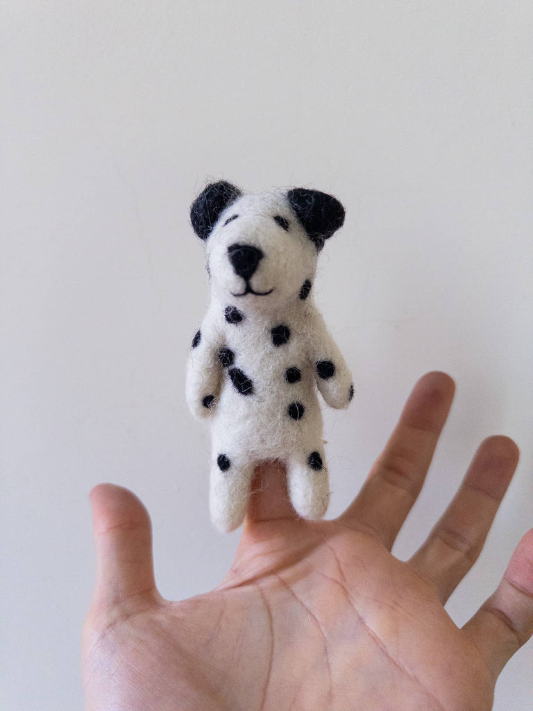 The Felt Finger Puppet: Dalmatian features black spots and fits on a finger, shown above an open hand against a white background—ideal for imaginative play.