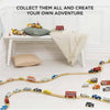 The London Toy Car Set features classic vehicles arranged on a train track in a cozy, bright room. Text reads: "COLLECT THEM ALL AND CREATE YOUR OWN ADVENTURE.