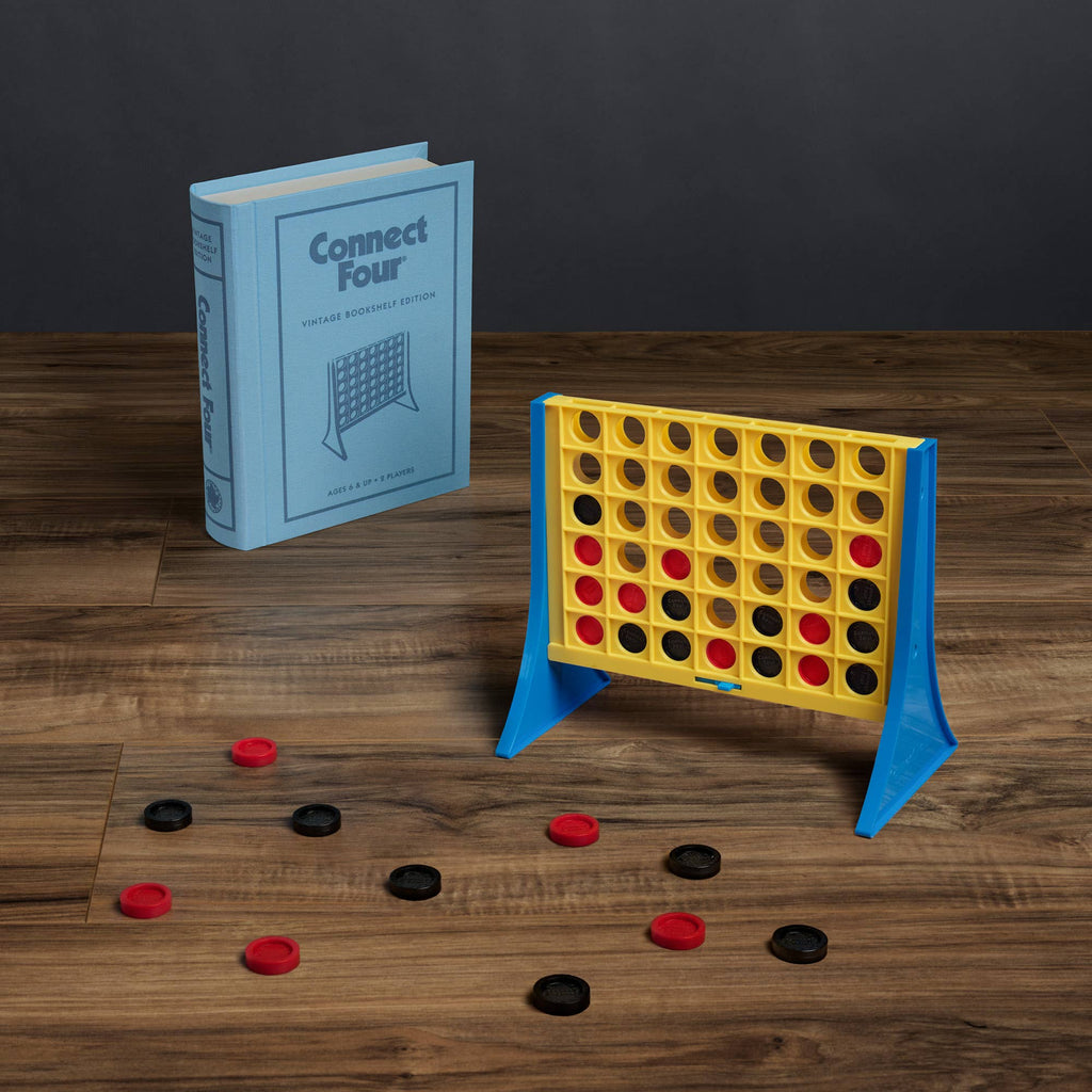 The Board Game: Connect 4 Vintage Bookshelf Edition features a collectible wooden game with a yellow and blue grid, black and red checkers, and comes in a stylish blue book-style box for display.