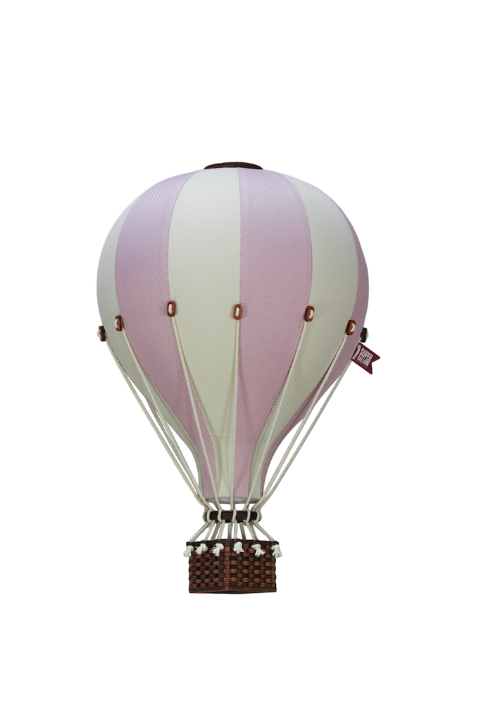 The Hot Air Balloon - Lilac features alternating lilac and white panels, a small woven basket, and a tiny flag—perfect as handmade children's room decor, shown isolated on a white background.