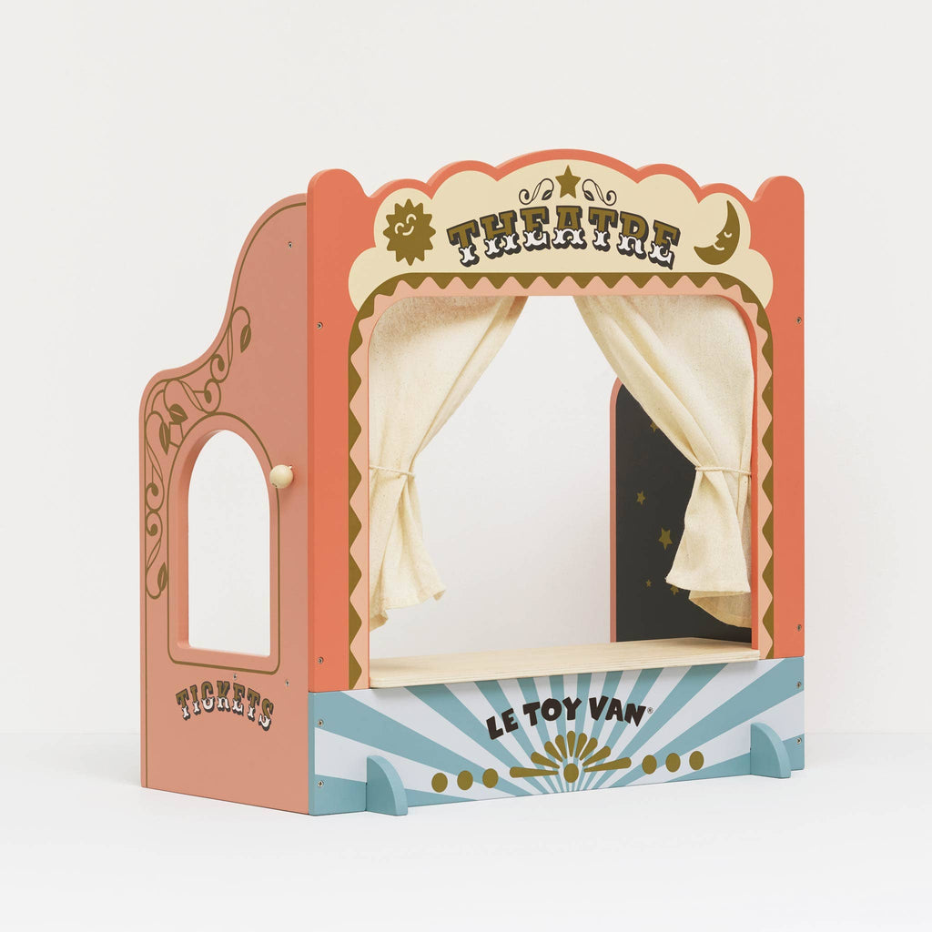 The Tabletop Puppet Wooden Theater features colorful wood, a “THEATRE” sign, cream curtains, “Le Toy Van” branding on the base, a “TICKETS” side panel, and playful patterns with a sunburst design—perfect for imaginative play.