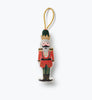 Nutcracker Embroidered Ornament featuring a nutcracker in a red uniform, gold crown, and green cap with a gold hanging cord.