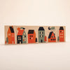 A row of colorful, stylized Uncle Goose Environments Neighborhood Blocks shaped like houses and trees, arranged sequentially on a light background. Each block features unique designs, including rooftops and windows.