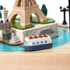 The Paris Music Box features a small toy boat floating on blue, with miniature wooden models of the Eiffel Tower and Paris landmarks, creating a charming, classic scene inspired by hand-cranked music boxes.