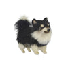 The Pomeranian Dog Stuffed Animal by HANSA is a beautifully hand-sewn plush toy with black and white fur, standing on all four legs and facing slightly to the right against a plain white background.