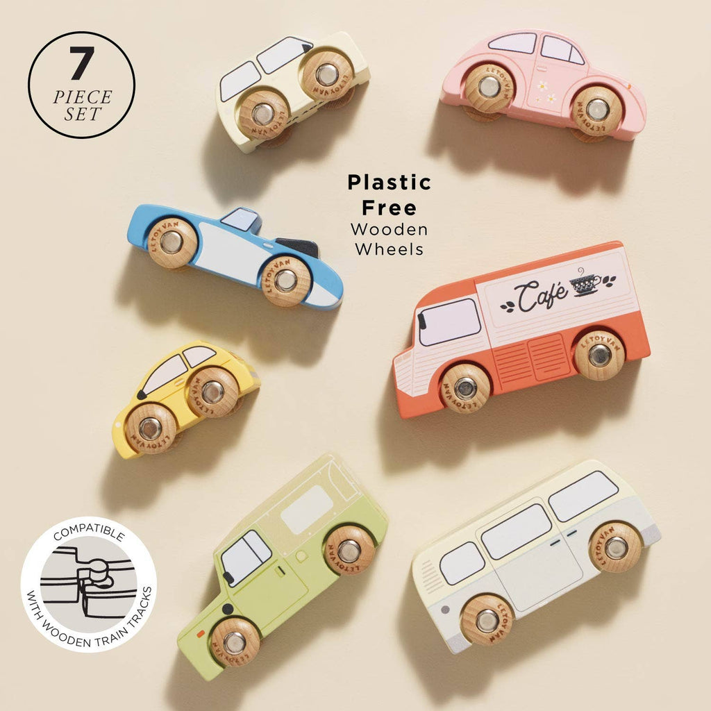 The Vintage Toy Cars set features seven colorful, plastic-free wooden cars with wooden wheels, crafted from FSC-certified wood and compatible with wooden train tracks, displayed on a beige background.