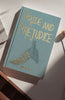 A collector’s edition hardcover of "Pride and Prejudice" by Austen, with gold lettering and a peacock design, rests on a sunlit light surface.